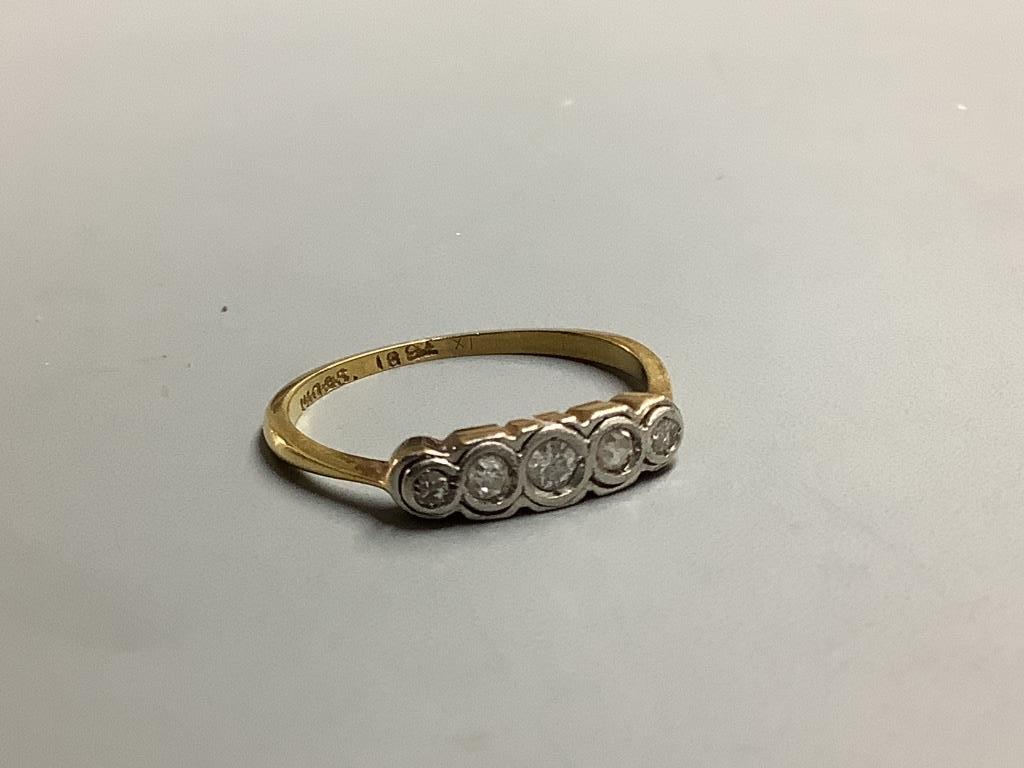 An 18ct and graduated five stone diamond ring, size M, gross 1.5 grams